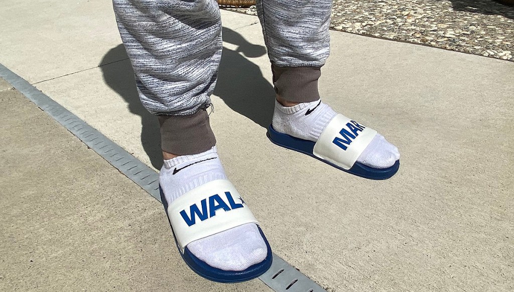 man wearing socks with walmart slides