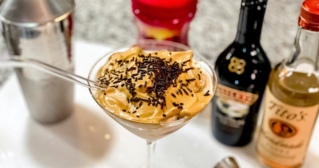 cocktail glass with whipped dalgona martini drink and chocolate sprinkles on top
