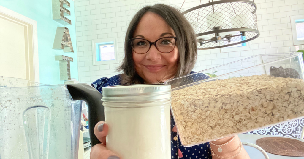 woman holding oats and homemade oat milk 