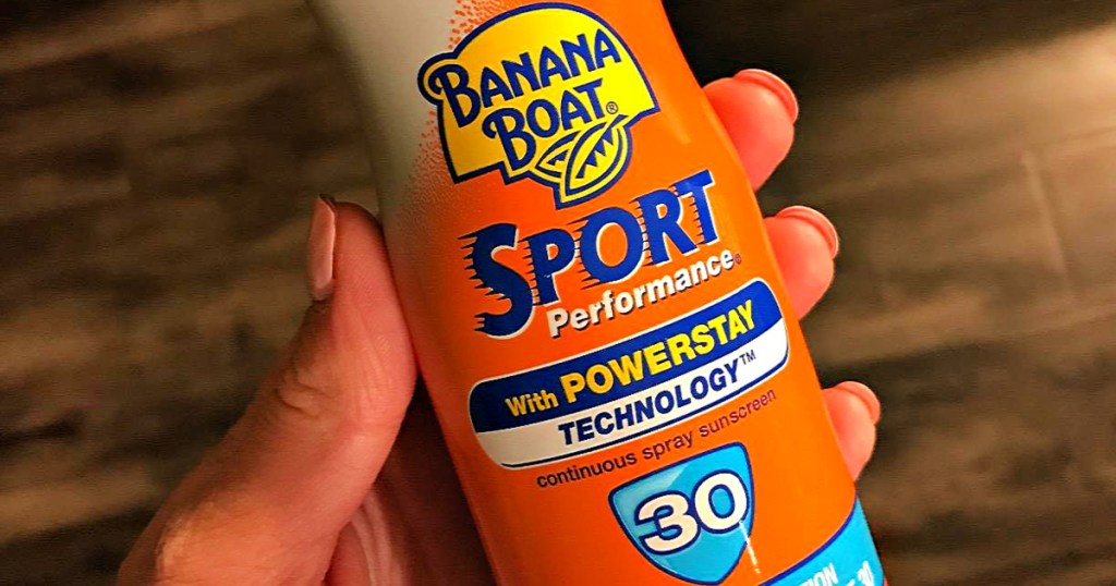 woman holding bottle of Banana Boat Spray Sunscreen Ultra Sport Performance SPF 30