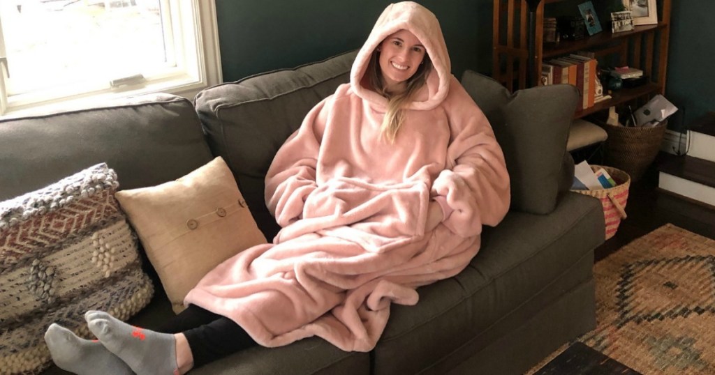 woman with wearable blanket laying on the couch 