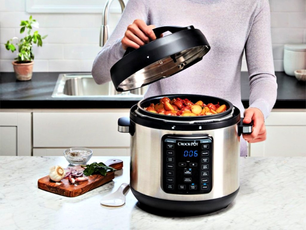 woman using a Crock-Pot Pressure Cooker in kitchen with stew