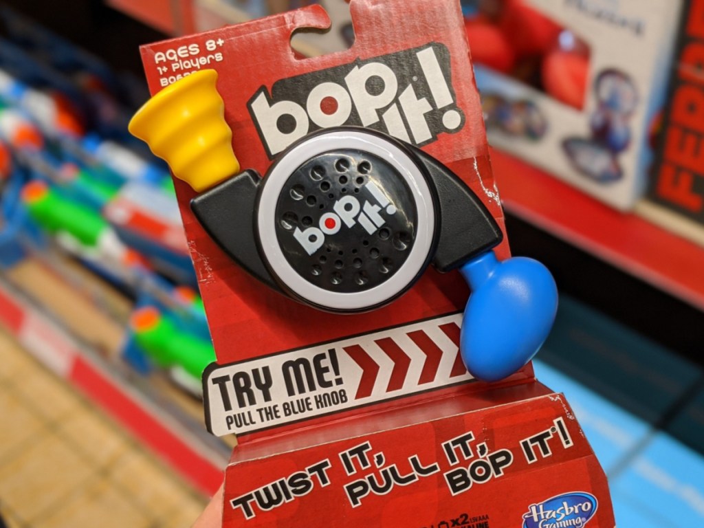 hand holding hasbro travel bop it! game in store