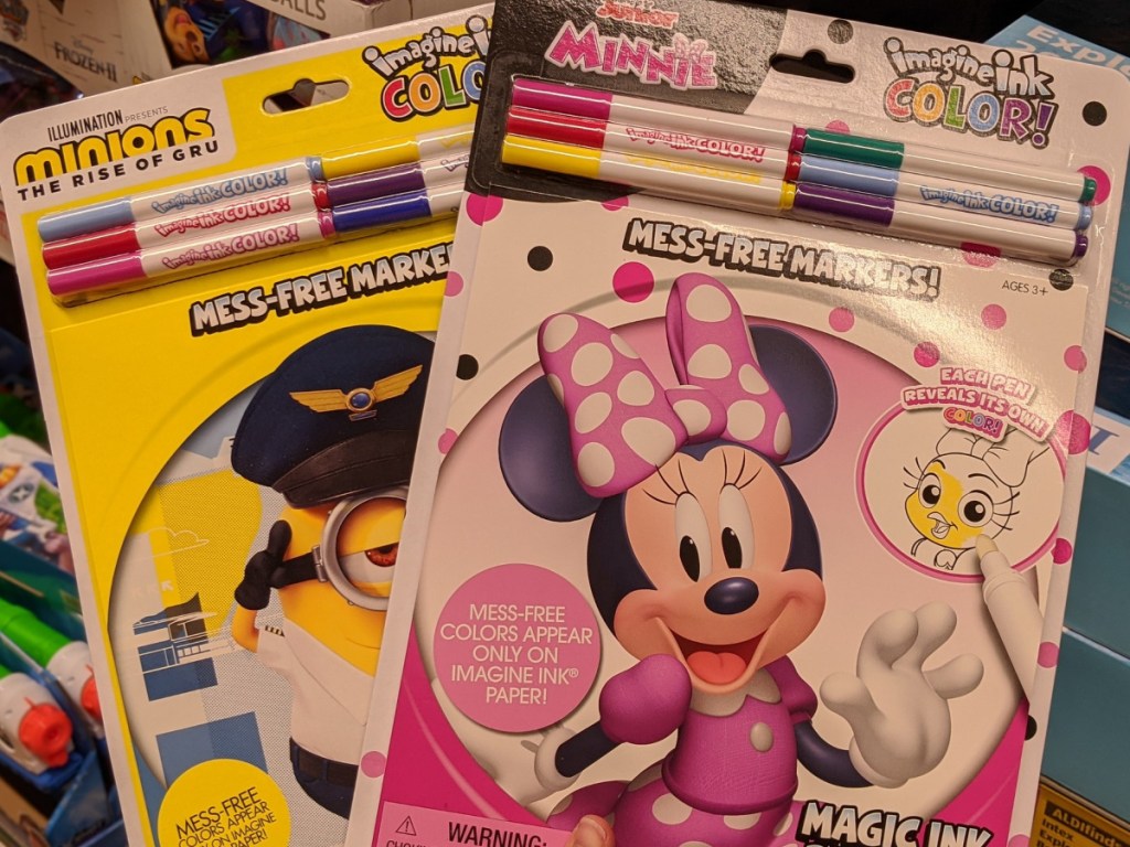hand holding minnie mouse and minions magic ink coloring books