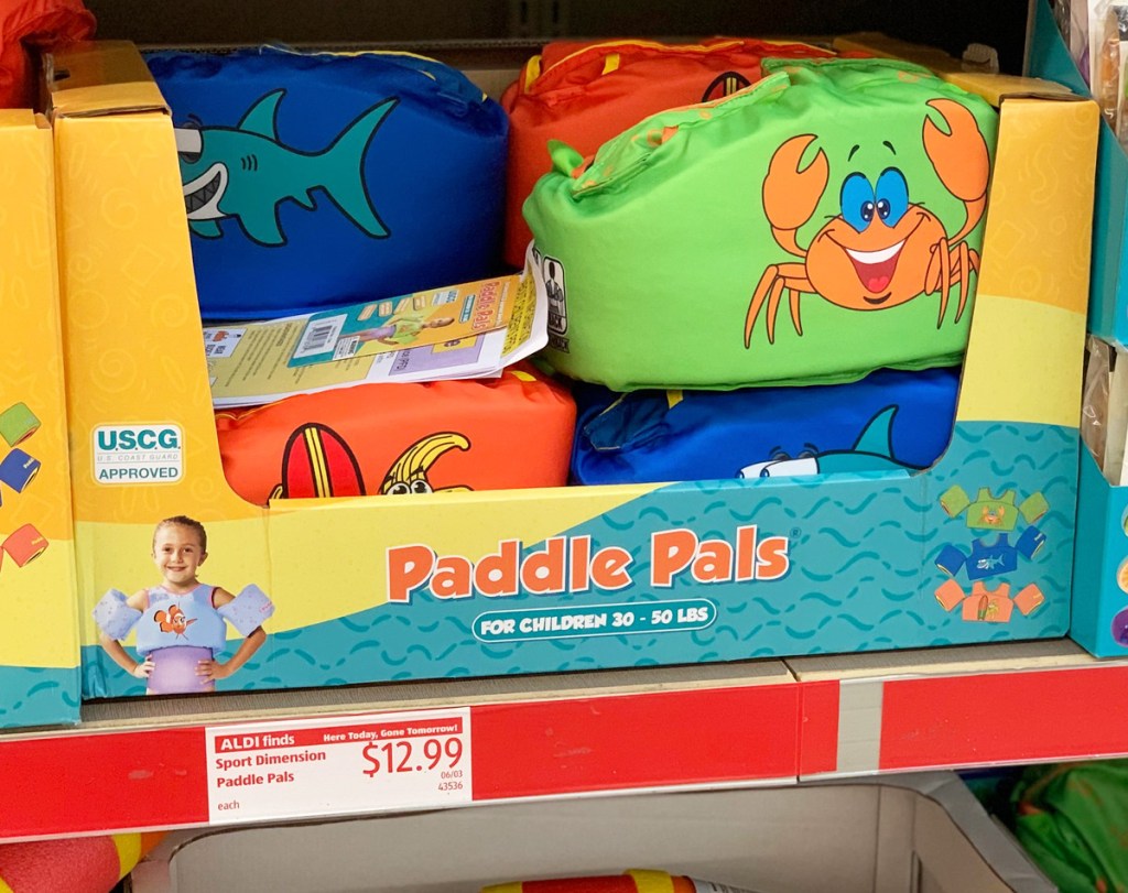 store display of colorful kids life jacket vests