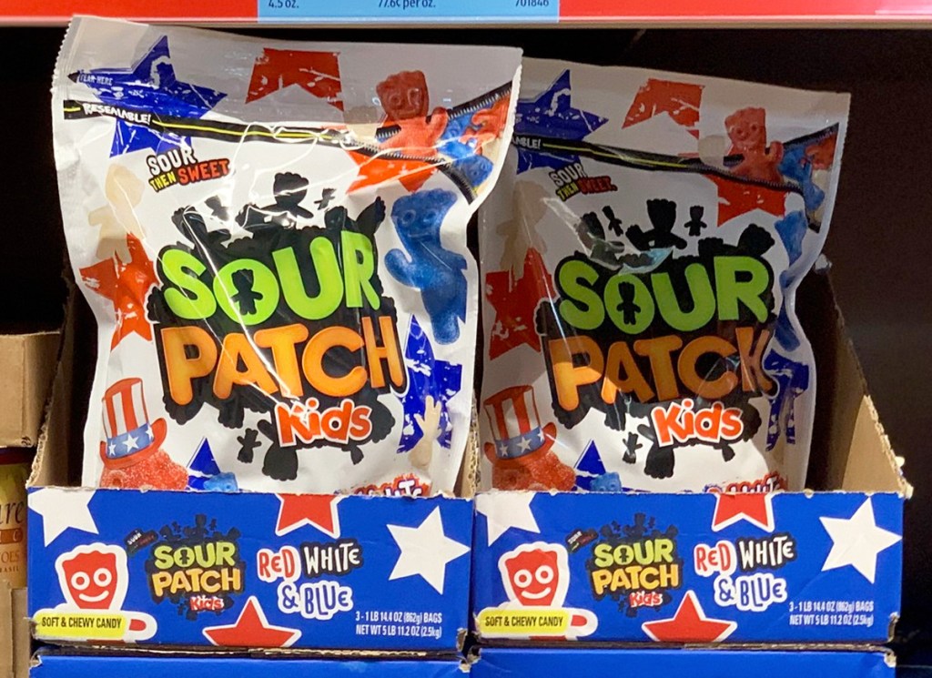 large white bags of red white and blue sour patch kids on store shelf