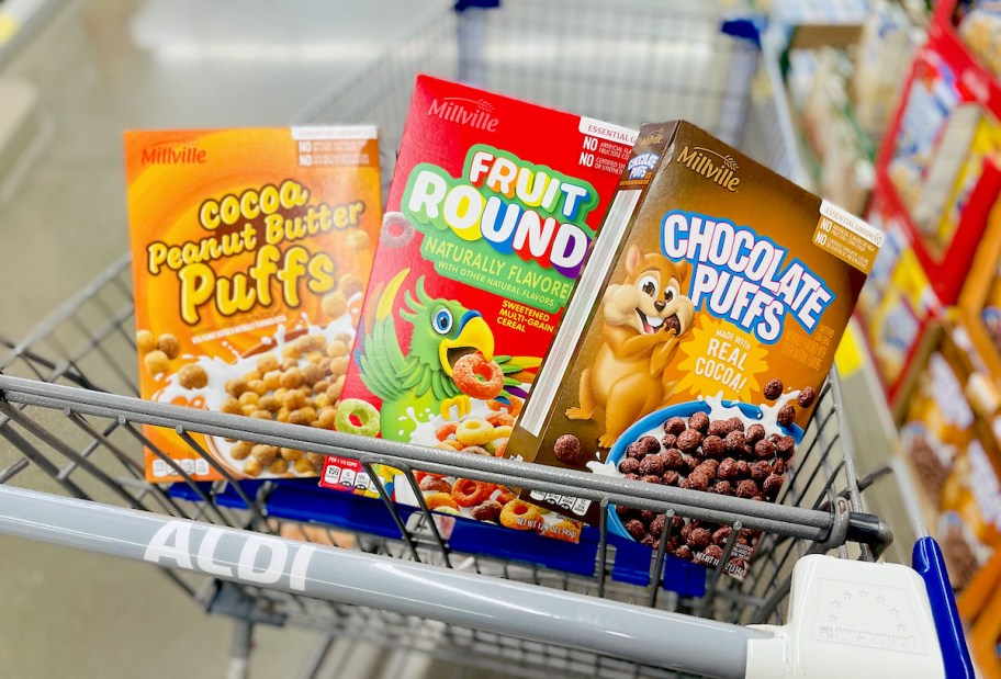 three boxes of millville cereal in top of store cart