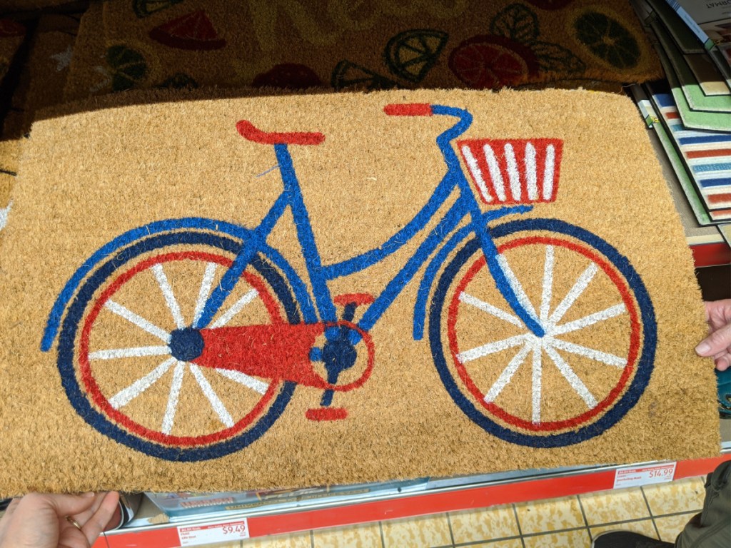 red white and blue bicycle themed doormat