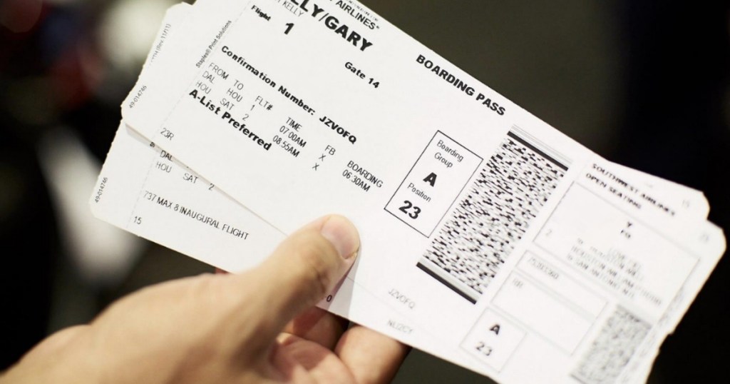 man holding airline tickets boarding passes
