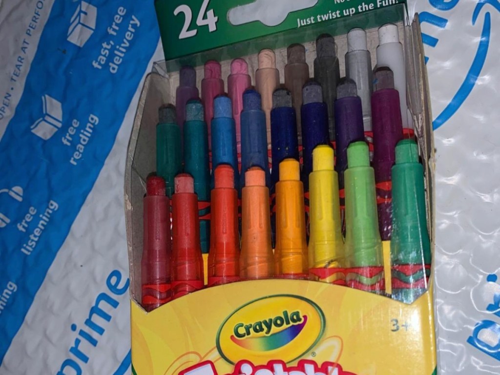 Crayola Twistables Crayon box sitting on a amazon prime package