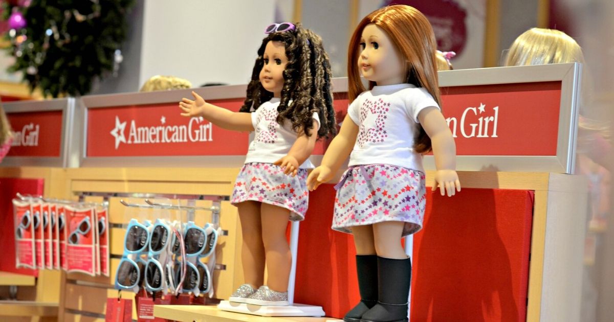 American Girl store display with 2 dolls and sunglasses