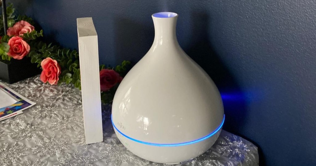 Anjou white oil diffuser on end table