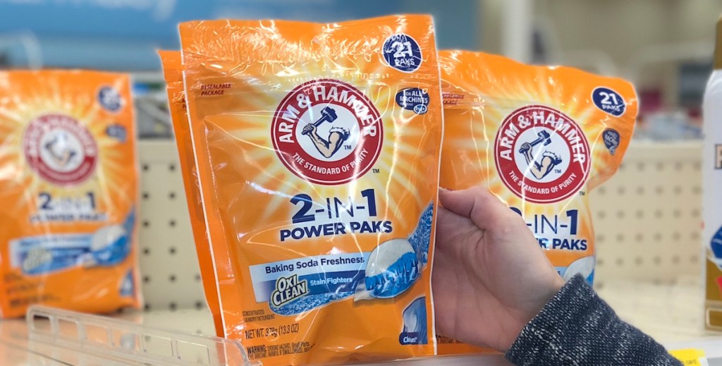 hand grabbing package of laundry detergent