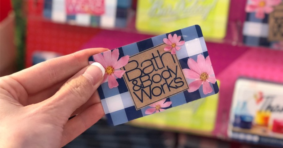 hand holding a Bath & Body works gift card