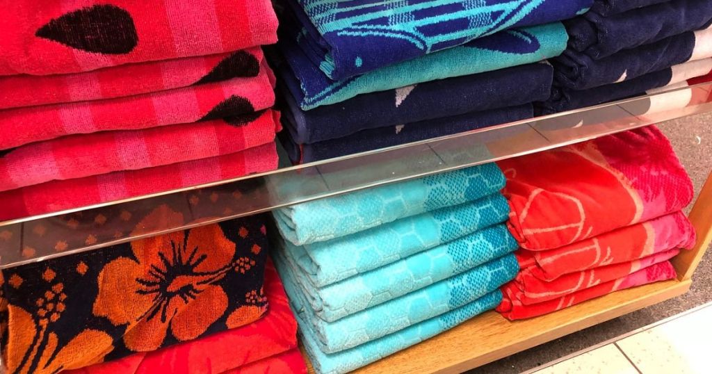 Beach towels on shelves at a store