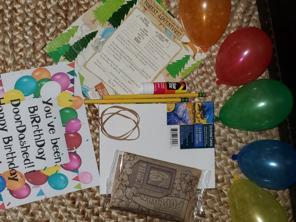 birthday printables, pencils, glue stick, sketch paper, popcorn and balloons