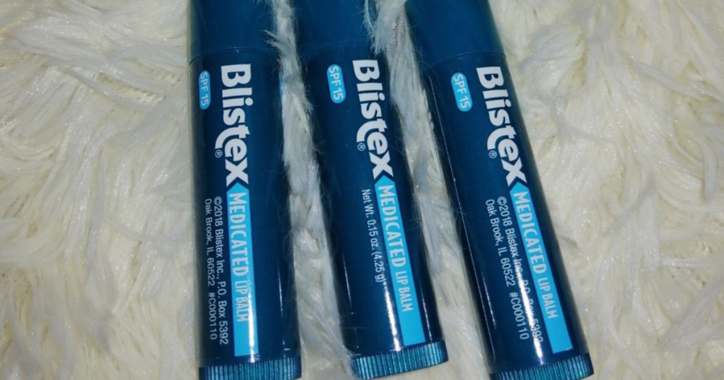 three sticks of blistex lip balm laid out in a row