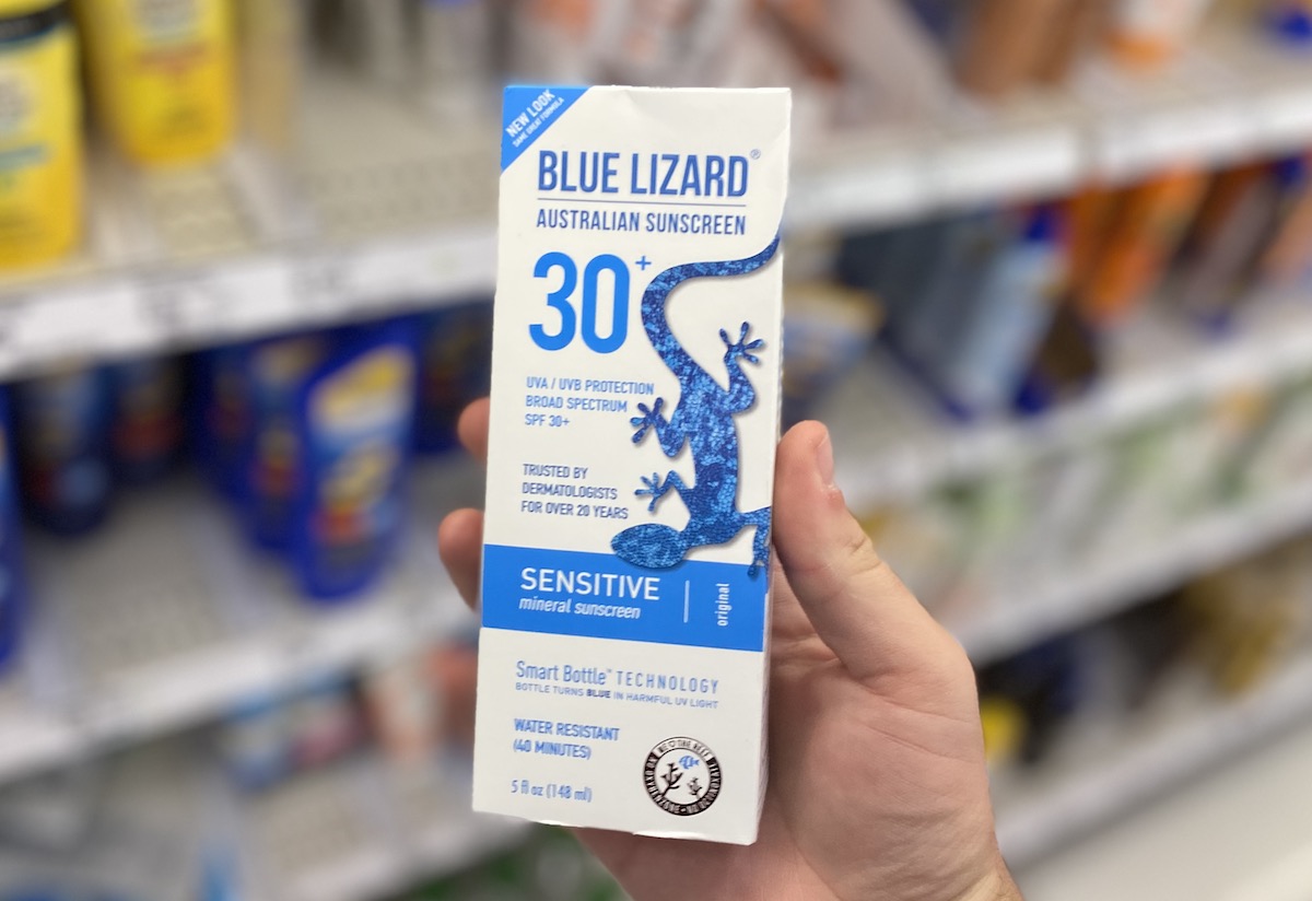 hand holding blue lizard sunscreen box inside target