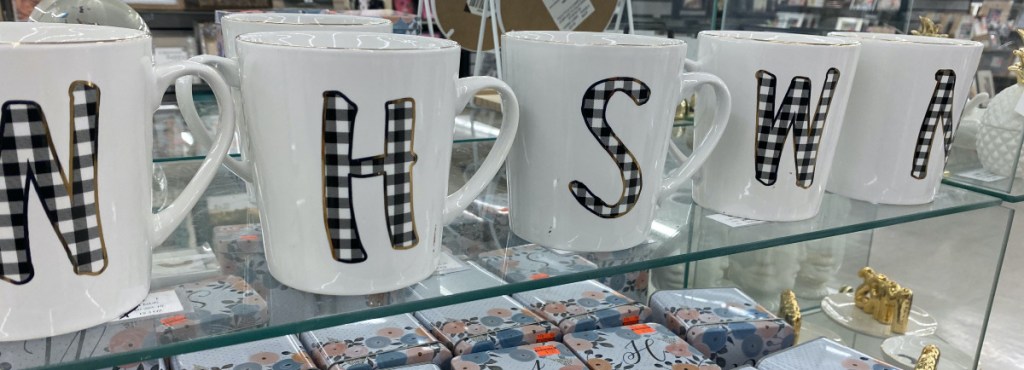 white and buffalo check monogrammed mugs on store shelf
