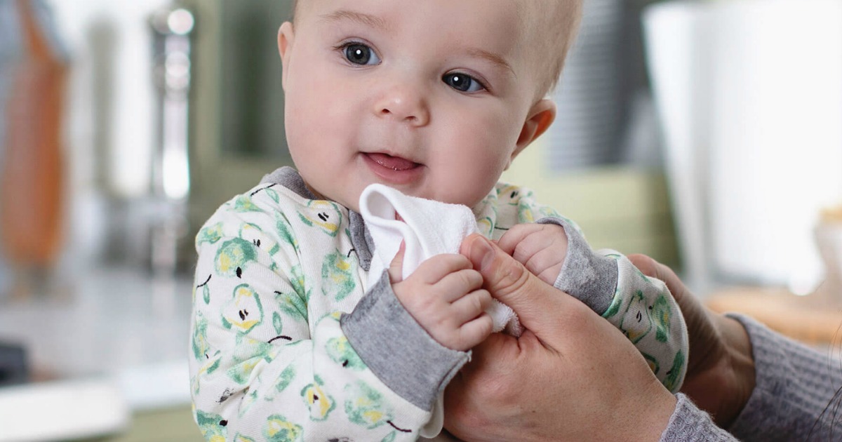 baby holding a washcloth