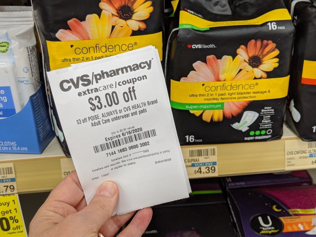 Hand holding CVS coupon