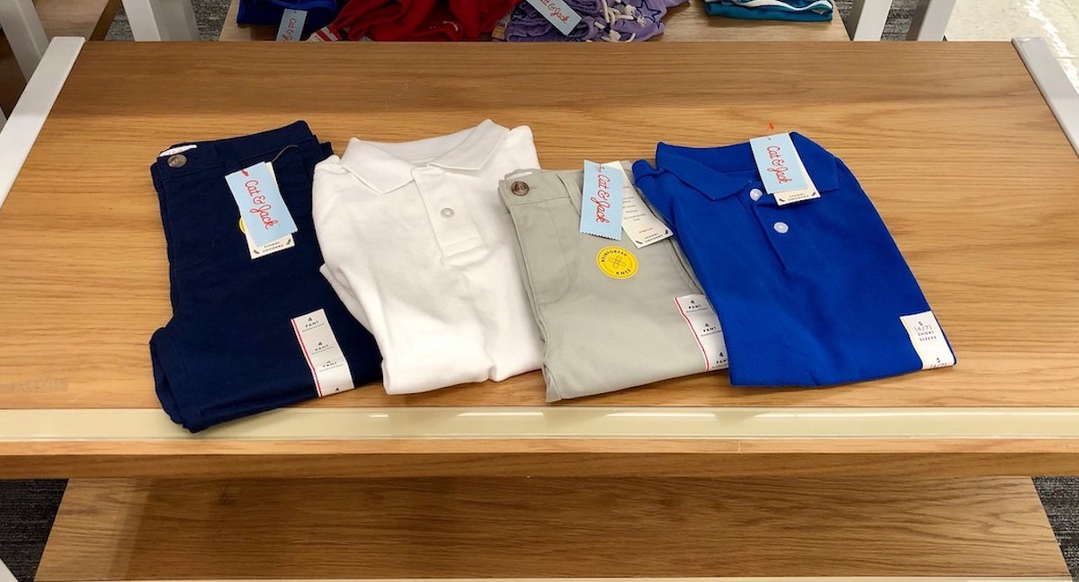 Cat & Jack uniform polo shirts and pants on table