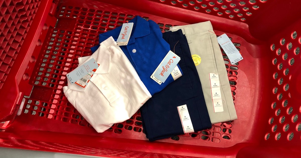 cat and jack uniform pants and polos in the bottom of a target cart