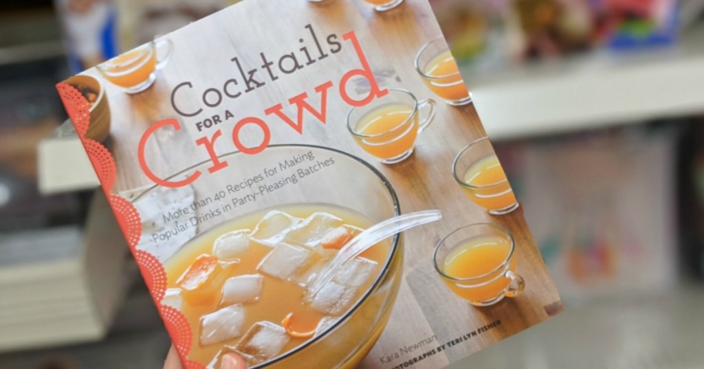 hand holding a Cocktails for a Crowd Cookbook