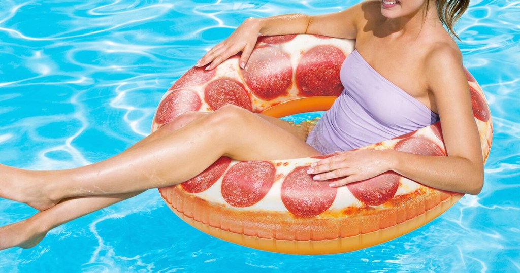 woman floating in pool in a pepperoni pizza pool float