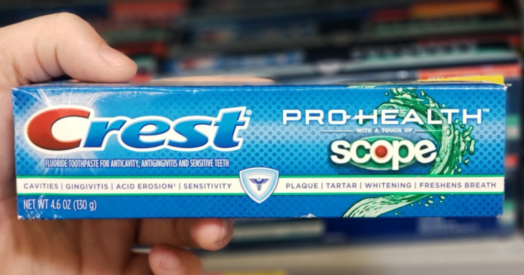 hand holding crest prohealth tube of toothpaste