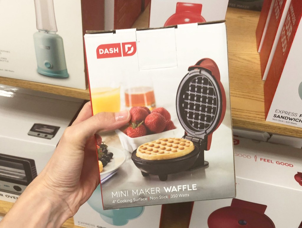 person holding a white box for a red mini waffle maker