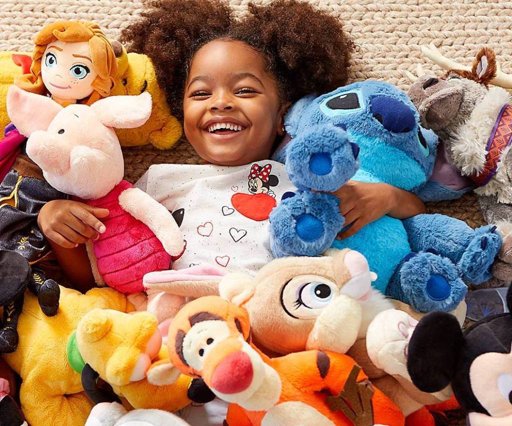 girl surrounded by stuffed animals