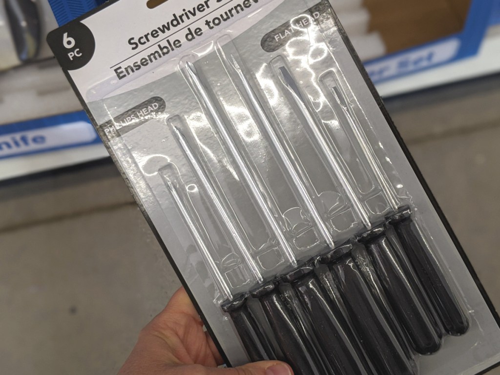 hand holding a 6-piece screwdriver set in-store at dollar tree