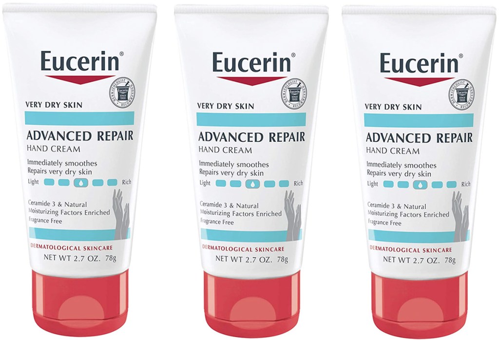 three white tubes with red lids of eucerin hand cream