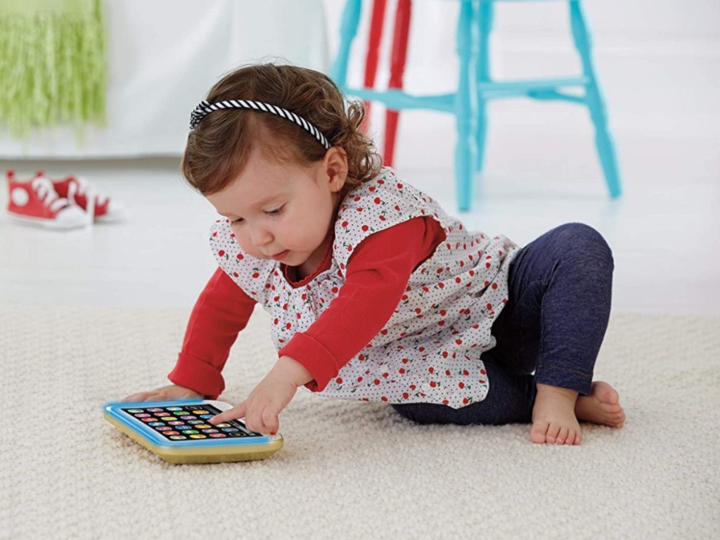 little girl playing with tablet