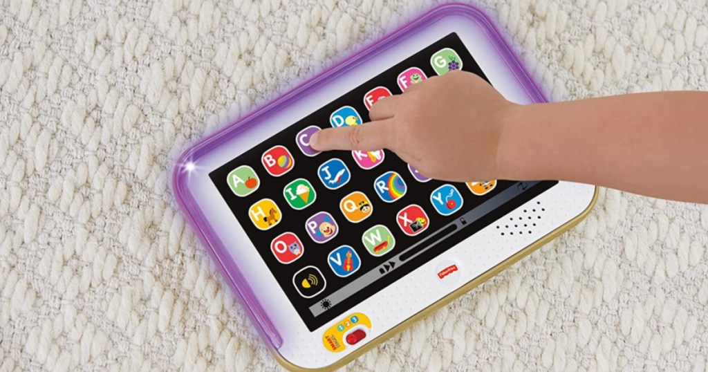 hand touching letters on kid tablet