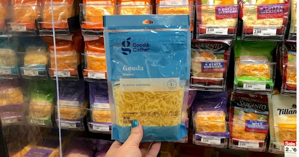 holding bag of Good & Gather shredded cheese at Target 