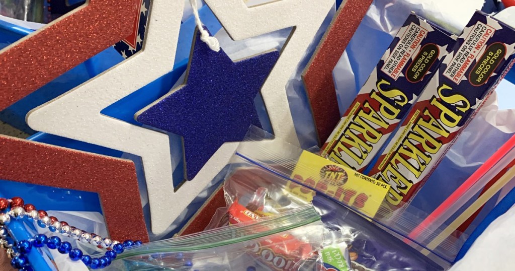 4th of july themed gift basket with candy, glow sticks, and sparklers inside