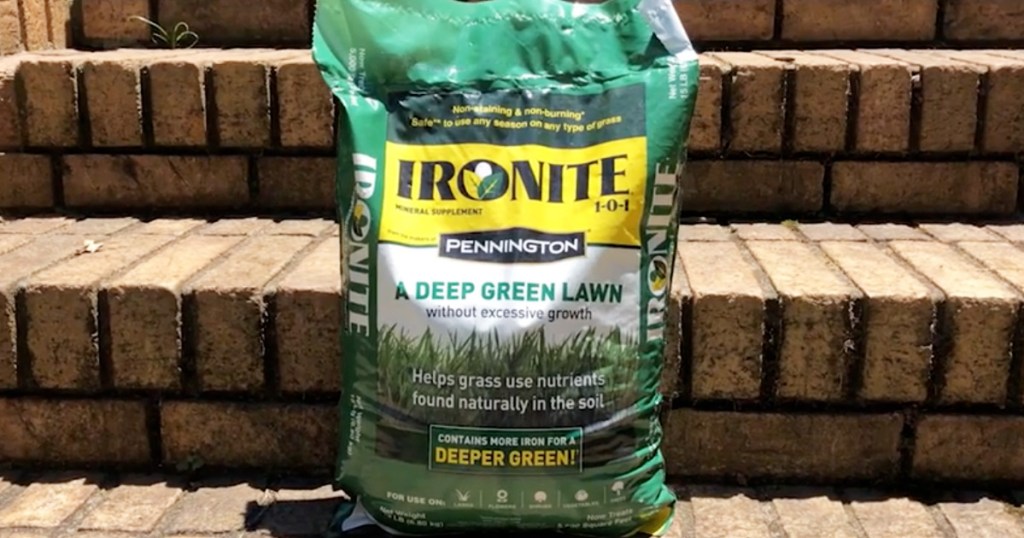 green and yellow bag of ironite lawn supplement sitting on brick steps