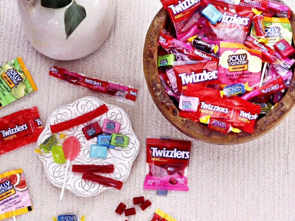 various fun size candies on table and in bowl