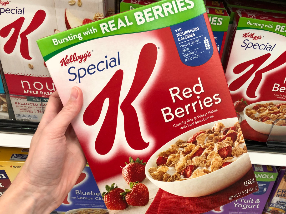 hand holding box of red berries cereal in store