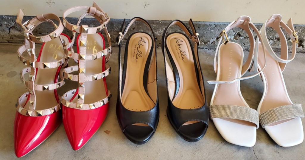 three pairs of heels lined up against wall