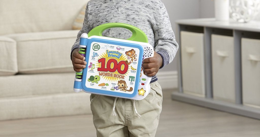 boy holding closed LeapFrog Learning Friends 100 Words Book