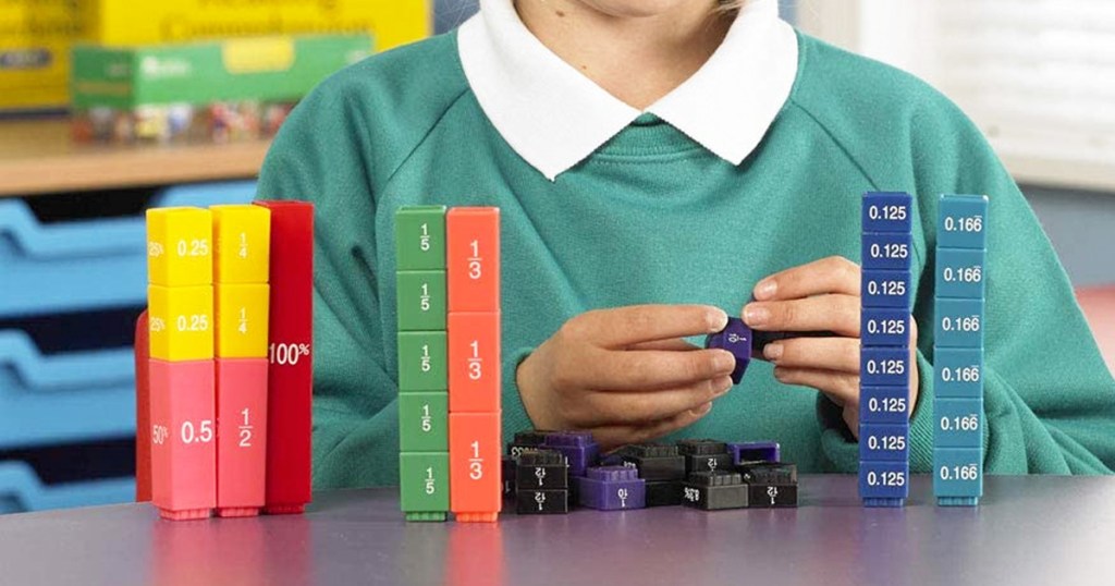 girl playing with colorful blocks that snap together to create whole towers with fractions and percentages printed on each block