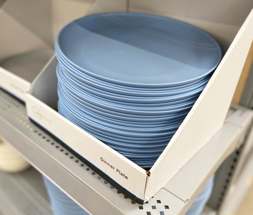 stack of light blue plastic dinner plates on store shelf