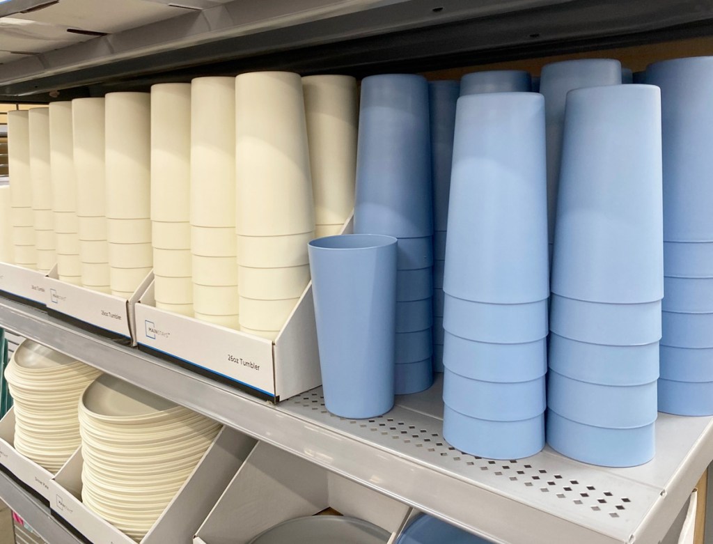 stacks of white and light blue plastic cups on store display shelf