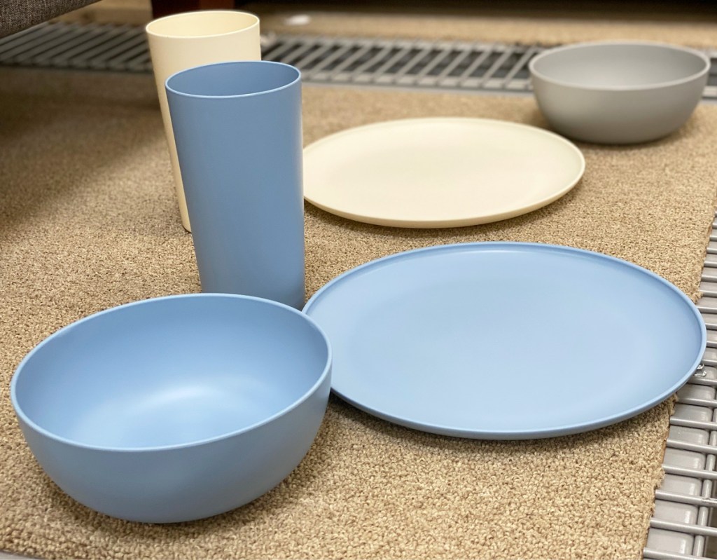 white, light blue, and grey plastic dinnerware on store display shelf