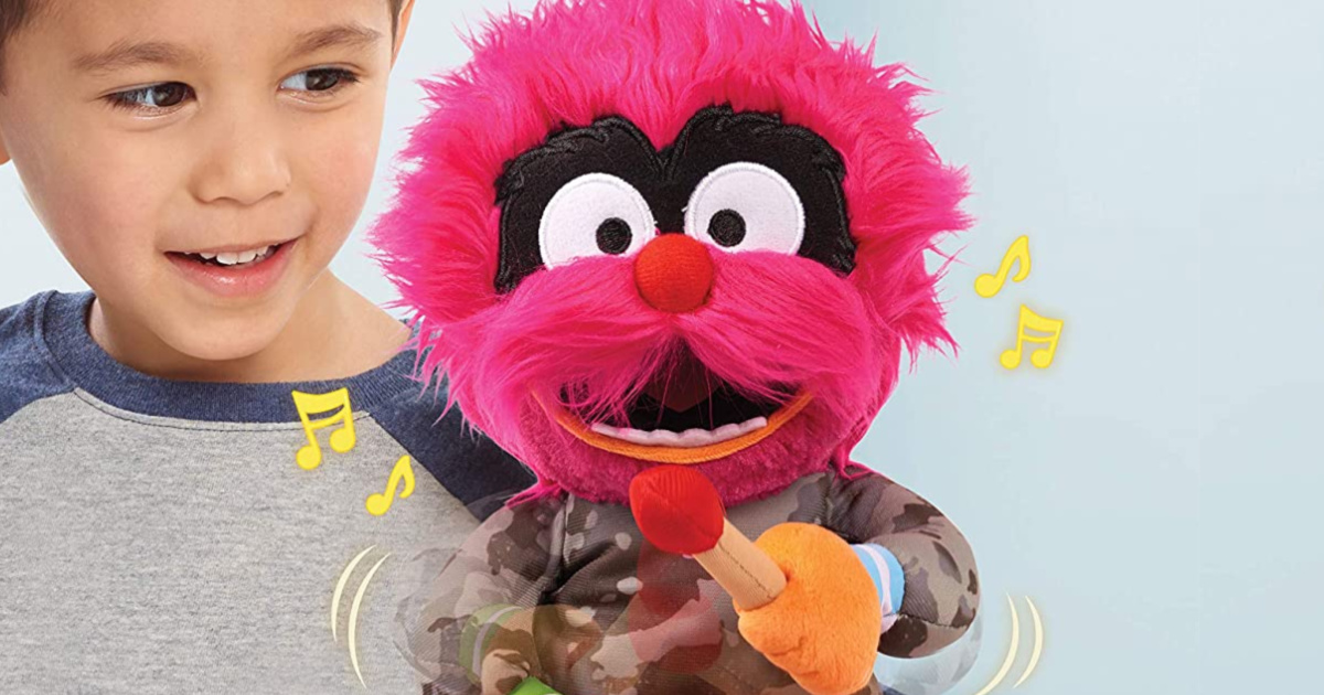 child playing with singing animated Muppet plush