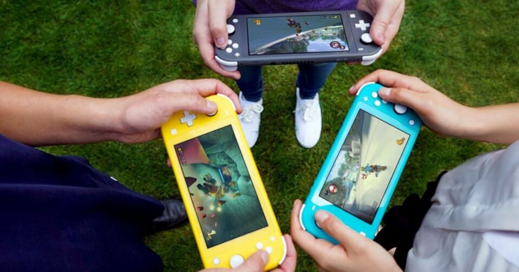 three kids holding nintendo switch lite handheld consoles