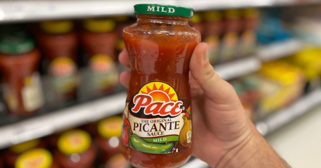 hand holding jar of salsa in store